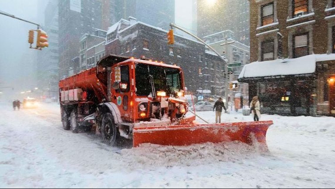 Truck plowing snow in the city